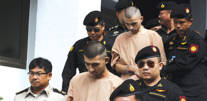 Suspects in the Bangkok blast, referred to as Yusufu Mieraili (second left), and Bilal Mohamed (also known as Adem Karadag), are escorted by soldiers 