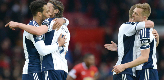 West Brom players celebrate their win over Manchester United yesterday.
