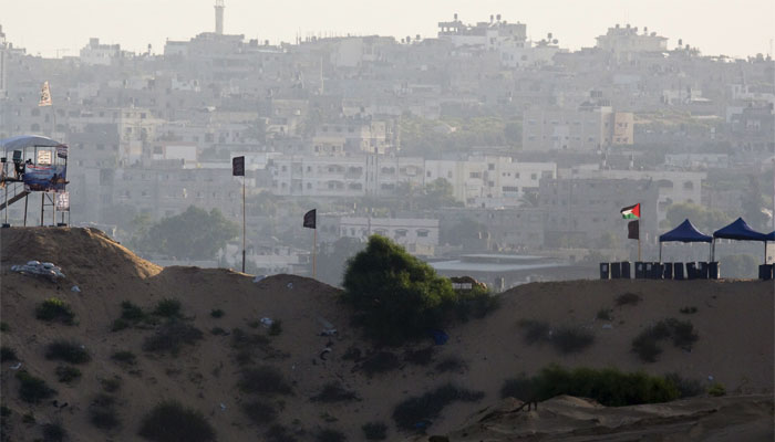 A Palestinian flag flutters near a watch tower in northern Gaza near the border with Israel.