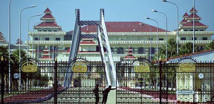 Police personnel open the gates to the Myanmar parliament in Naypyidaw yesterday.