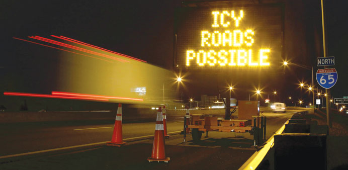 A travel sign warns motorists along Interstate 65 as a cold weather front descended on Mobile, Alabama.