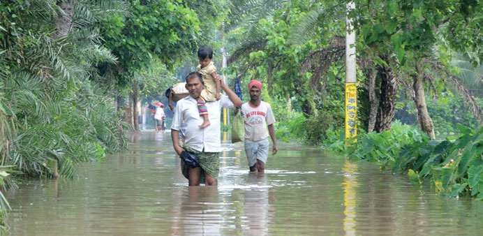 Villagers wade through floodwaters in Bherampur block of Murshidabad district, some 220km north of Kolkata.