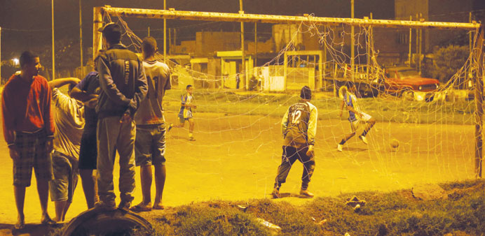 Youngsters play football at the Anita Garibaldi shantytown in Sao Paulo.