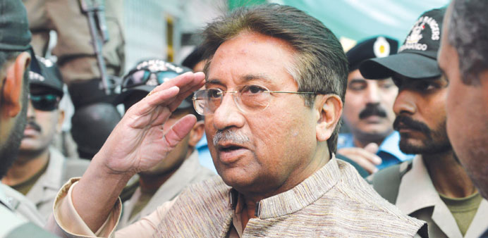 In this photograph taken on April 20, 2013, former Pakistani president Pervez Musharraf salutes as he is escorted by soldiers as he arrives at an anti