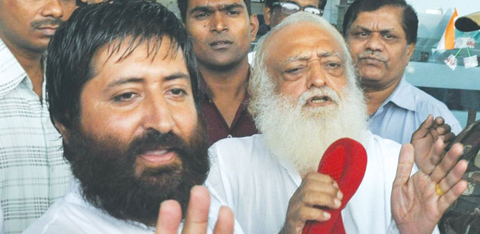 Asaram Bapu and his son Narayan Sai (left) miss their flight at Raja Bhoj airport in Bhopal. Asaramu2019s men manhandled media personnel trying to take hi