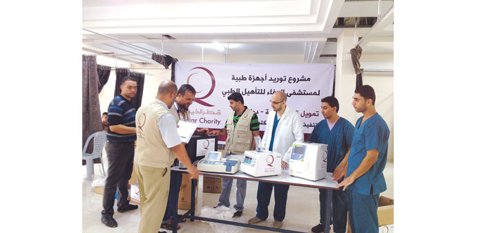 QC officials handing over some of the donated equipment.