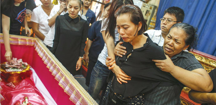 Noppawan Chairat (second right), the mother of a pair of siblings killed in Sundayu2019s bomb blast near an anti-government protest site, mourns during th