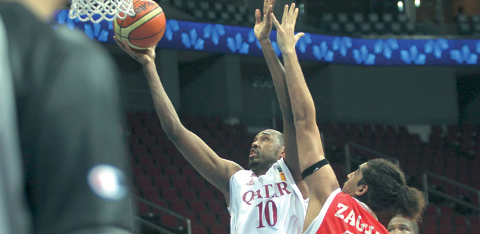 Qataru2019s Yaseen Mussa (left) goes for the basket during their match against Jordan in the Asian Basketball Championship in Manila yesterday. PICTURE: O