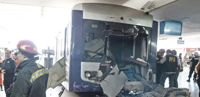 Firefighters work at the site of a train accident at Once station in Buenos Aires yesterday.