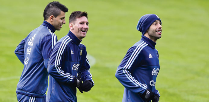 Argentinau2019s Lionel Messi (centre), Sergio Aguero (left) and Javier Mascherano jog during a training session in Concepcion, Chile.