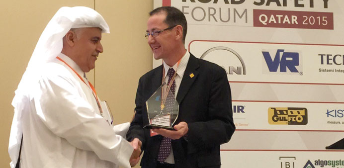 Brig al-Malki receiving the award in Doha yesterday.