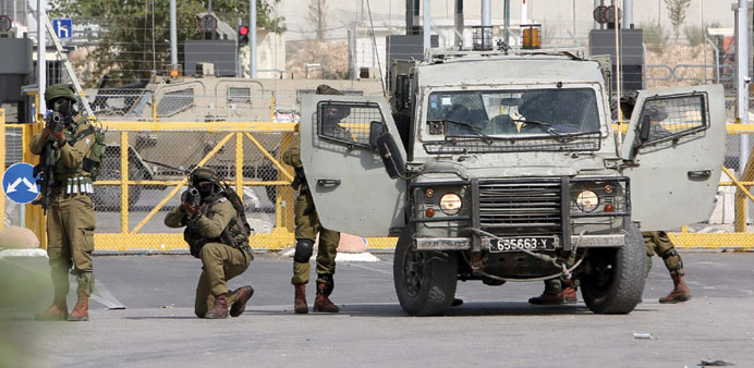 Israeli security forces fire teargas canisters to prevent Palestinians from approaching the Al Jalama checkpoint, located north of the West Bank town 