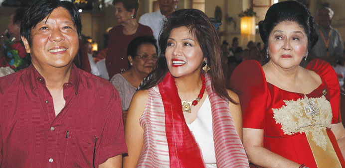 Senator Ferdinand Marcos Jr (left) and Ilocos Norte Governor Imee attend mass on the 85th birthday of their mother Imelda Marcos in their hometown of 