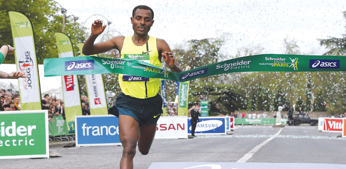 Kenenisa Bekele of Ethiopia crosses the finish line to win the 38th editon of the Paris Marathon yesterday. (Reuters)
