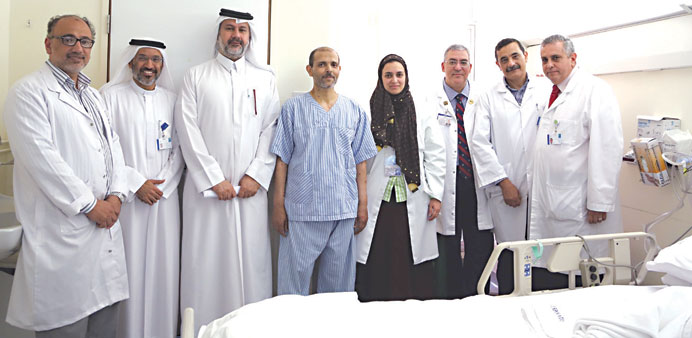 The patient (fourth from left) poses with the HMC team.