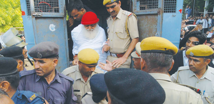 Asaram Bapu is escorted by police to a court in Jodhpur yesterday.
