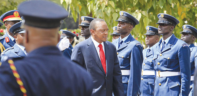Kenyatta inspecting the guard of honour as he arrived at the Parliament Building in Nairobi to deliver his state of the nation address.