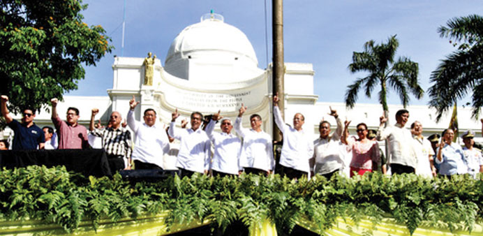 President Benigno Aquino  flashes the Laban sign along with other officials during rites to commemorate the 28th anniversary of the Edsa People Power 