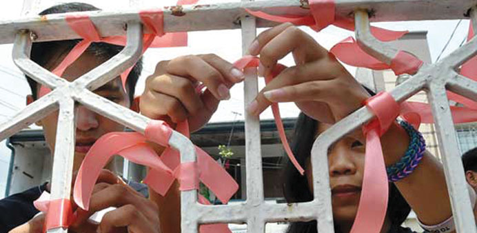 Members of the anti-DAP group, u201cScrap the Pork Allianceu201d tie ribbons to the gate of the Bayan office at the NDC Compound in Sta. Mesa, Manila yesterda