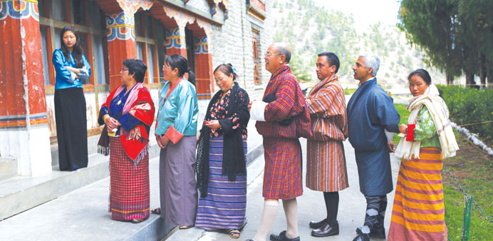 Residents queue as they wait to cast their votes at a polling station in Thimphu yesterday, during the second parliamentary elections of Bhutan.