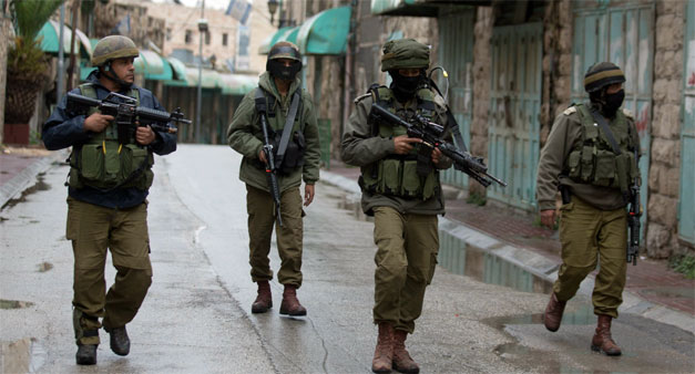 Israeli soldiers patrol near the Jewish settlement of Beit Hadassah in the Israeli-occupied city of Hebron