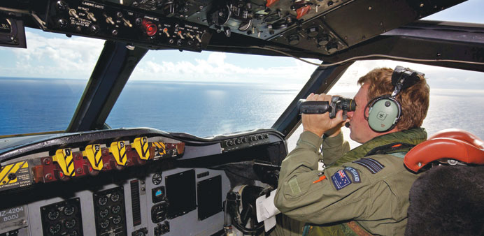 A picture made available yesterday shows co-pilot Sqn Ldr Brent McKenzie of a Royal New Zealand Air Force (RNZAF) P-3 Orion taking part in the search 