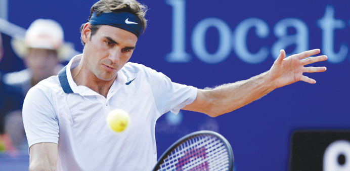 Switzerlandu2019s Roger Federer returns the ball to Germanyu2019s Daniel Brands during their Suisse Open match in Gstaad yesterday. (Reuters)