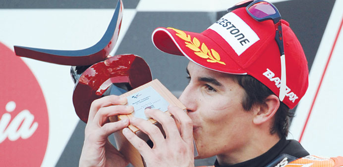 Repsol Honda team rider Marc Marquez of Spain kisses his second-place trophy on the podium after the MotoGP race of the Japanese Grand Prix at the Twi