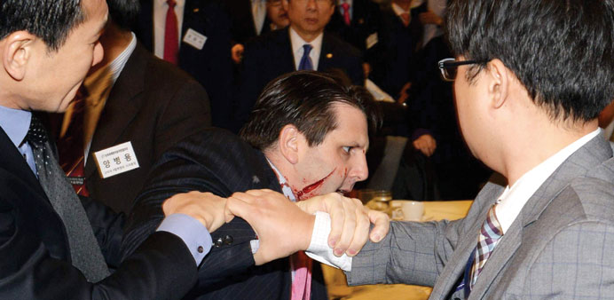 US ambassador to South Korea Mark Lippert leaves the Sejong Cultural Institute in Seoul, after being injured in an attack by an armed assailant.