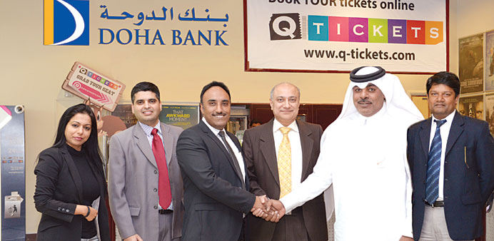 Doha Bank and Q-Tickets.com officials celebrate the 100,000 record for online ticket sales.