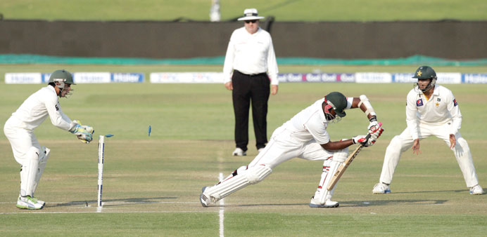 Zimbabwe batsman Hamilton Masakadza survives a stumping attempt by wicket keeper Adnan Akmal during the third day of the second Test in Harare yesterd