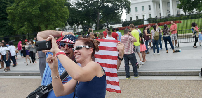 People pose for a selfie in front of the White House yesterday.