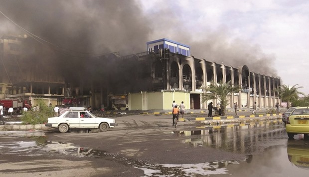 Smoke rises from a mall after clashes in Yemenu2019s southern port city of Aden yesterday.