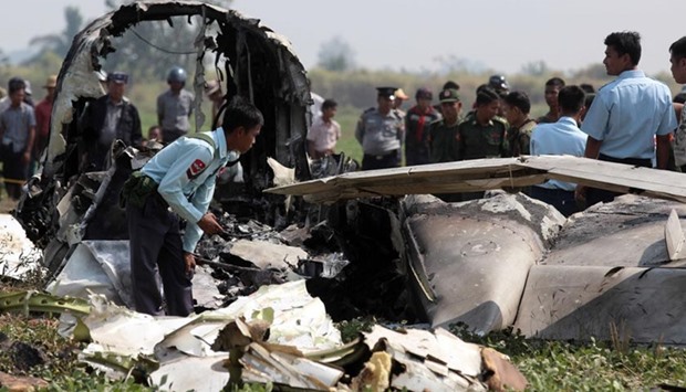 Myanmar army officials inspect the wreckage of a military passenger plane which crashed in Naypyidaw on Wednesday.