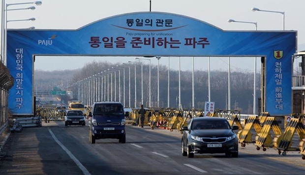 Vehicles cross the Tongil bridge leading away from the Kaesong joint industrial area and the Demilitarized Zone (DMZ) between the two Koreas, in Paju, on Wednesday.
