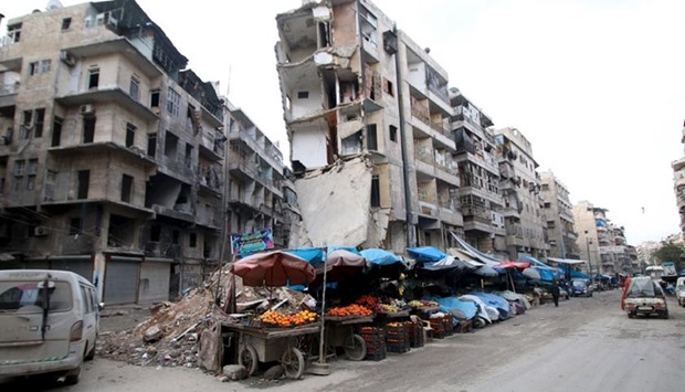 Stalls are seen on a street beside damaged buildings in the rebel held al-Shaar neighbourhood of Aleppo, on Wednesday.