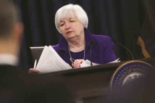 Federal Reserve chair Janet Yellen collects her papers during a news conference to announce raised interest rates in Washington on December 16. In the 52 days since investors last heard from Yellen, markets have been roiled with volatility and increasing doubt about the health of the US and global economies.