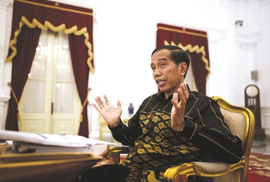 Indonesian President Joko Widodo gestures during an interview with Reuters at the presidential palace in Jakarta yesterday. He said he was very optimistic that growth would rebound to 5.3% this year after a slide to 4.8% in 2015.