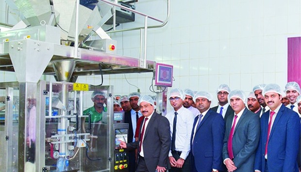 Quality Group chairman Shamsudheen Olakara switching on the fully automatic food packing unit as oth