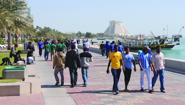 Residents walking along the Corniche on National Sport Day.