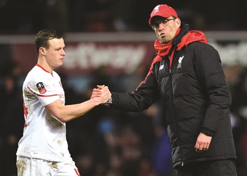 Liverpool manager Jurgen Klopp (R) shakes hands with defender Brad Smith after the English FA Cup fourth round replay.
