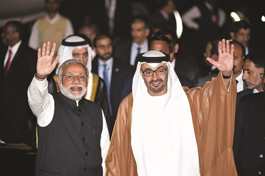 Modi and Sheikh Mohamed bin Zayed al-Nahyan wave to the crowd after the Abu Dhabi crown prince arrived at an air force base in New Delhi yesterday.