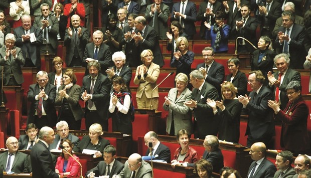 Fabius (bottom left) acknowledges applause from lawmakers during the session at the National Assembly in Paris yesterday. The French foreign minister announced yesterday that he was leaving the government.