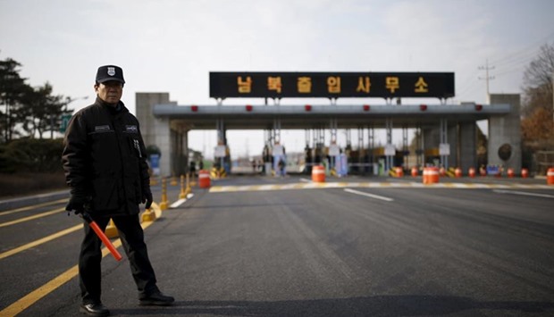 A South Korean security guard stands on an empty road which leads to the Kaesong Industrial Complex, just south of the demilitarised zone separating the two Koreas, in Paju on Thursday.