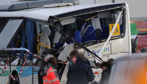 French police work near the wreckage of a school minibus after it crashed into a truck in Rochefort on Thursday.