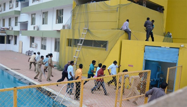 Indian employees of a private school on the outskirts of Bangalore running away from a leopard