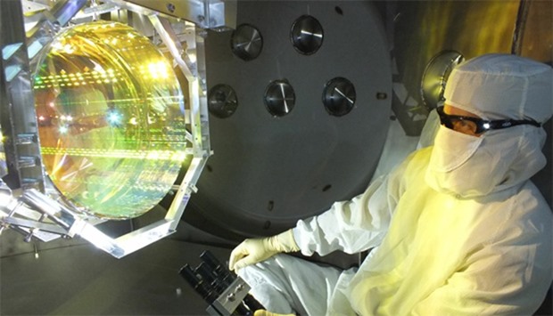 Laser Interferometer Gravitational Wave Observatory (LIGO) optics technician inspecting one of LIGOu2019