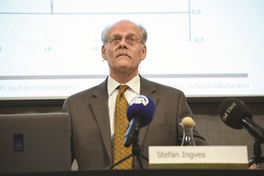 Central Bank of Swedenu2019s governor Stefan Ingves presents interest rates during a news conference at the headquarters in Stockholm yesterday. As policymakers battle to weaken their currencies against global rivals, the Riksbank chopped its repo rate to -0.50% from -0.35%, adding fuel to a borrowing boom that helped push house prices up 12% over the last year.
