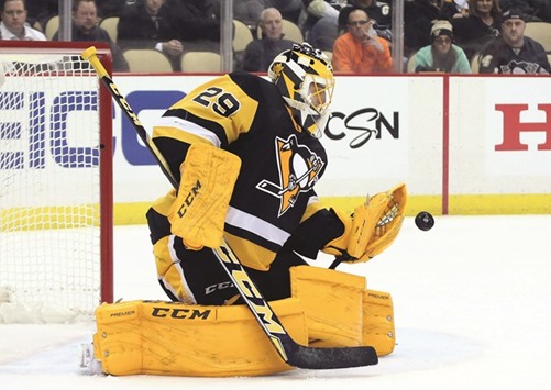 Pittsburgh Penguins goalie Marc-Andre Fleury (29) makes a glove save against Rangers.