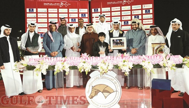 Qatar Society of Al Gannas president Ali bin Khatim al-Mehshadi, deputy president Mohamed Abdullateef al-Misnad and QREC general manager Nasser Sherida al-Kaabi with the winners of Marmi Cup, a Class 1 race for three-year-old thoroughbreds, at the QREC yesterday. PICTURES: Juhaim